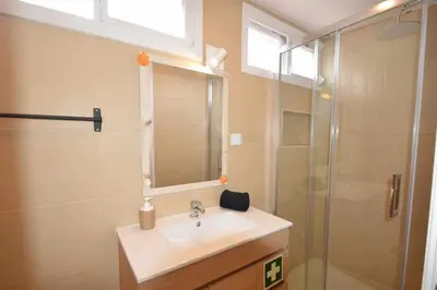 a bathroom with a sink and a shower at Casa das Areias in Albufeira