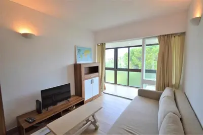 a living room with a couch and a tv at Casa das Areias in Albufeira