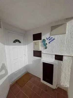a small room with a white door and a room with at Casa das Areias in Albufeira