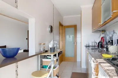 a kitchen with white walls and a counter top at Algarve Apartment, Faro - Excellent Location in Faro