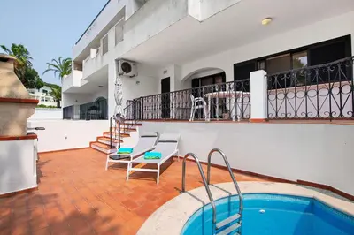 a balcony of a house with a swimming pool at Apartamento Tennis View in Almancil