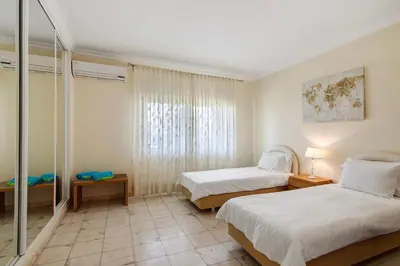 a bedroom with two beds and a mirror at Apartamento Tennis View in Almancil