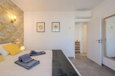 a bedroom with a bed with towels on it at Albufeira Old Town Sea View Apartment in Albufeira