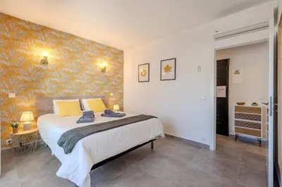 a bedroom with a large bed with yellow pillows at Albufeira Old Town Sea View Apartment in Albufeira