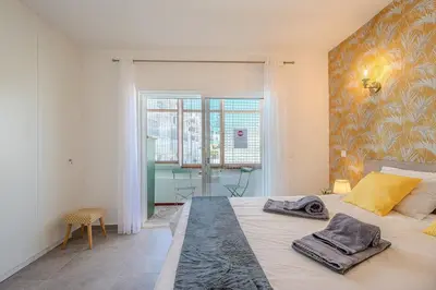 a bedroom with a large bed with towels on it at Albufeira Old Town Sea View Apartment in Albufeira
