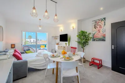a kitchen and a living room with a table and a couch at Albufeira Old Town Sea View Apartment in Albufeira
