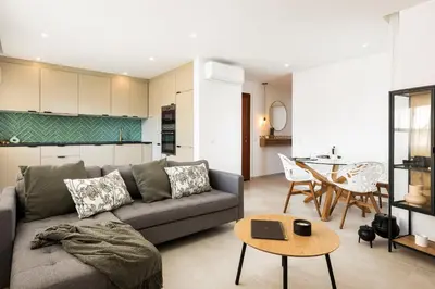 a living room with a couch and a table at The Marina Collection in Quarteira