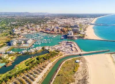 an aerial view of a beach and a city at The Marina Collection in Quarteira