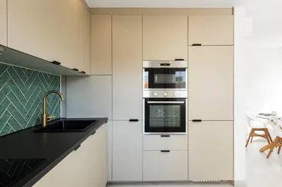 a kitchen with white cabinets and a stove at The Marina Collection in Quarteira
