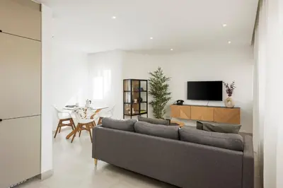 a living room with a gray couch and a table at The Marina Collection in Quarteira