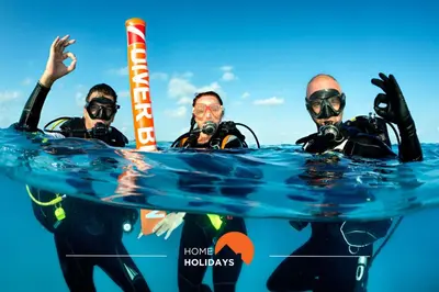 a group of three people in the water at #312 Ocean Outlook by Home Holidays in Páteo