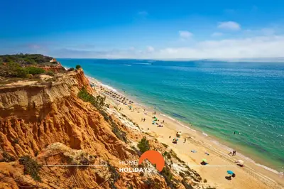 a view of a beach with people on a cliff at #312 Ocean Outlook by Home Holidays in Páteo
