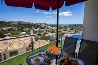 a table with a bowl of fruit and a view of the ocean at #312 Ocean Outlook by Home Holidays in Páteo