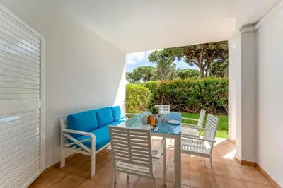 a dining room with a glass table and chairs at Apartamento Pine by Algarve Holidays in Roja- Pé
