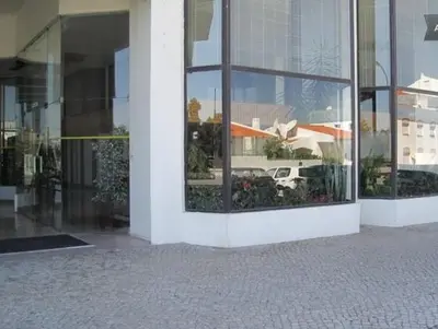a reflection of a building in the windows of a building at Apartamento Ariadna in Albufeira
