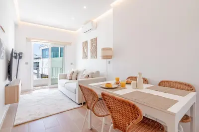 a white kitchen with white cabinets and a sink at Sandora Dune by Seareen in Albufeira