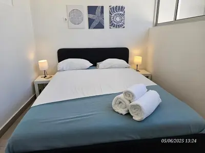 a bedroom with a bed with towels on it at Blife Montya private rooms in Faro