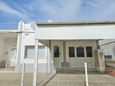 a white house with a fence in front of it at Blife Montya private rooms in Faro