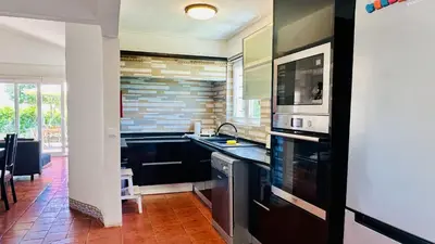 a kitchen with a sink and a microwave at Strip II by Check-in Portugal in Albufeira