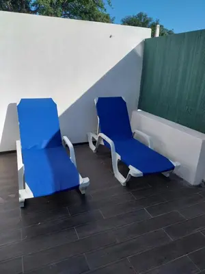 two blue chairs sitting on top of a roof at Albufeira Oura Apartment II in Albufeira