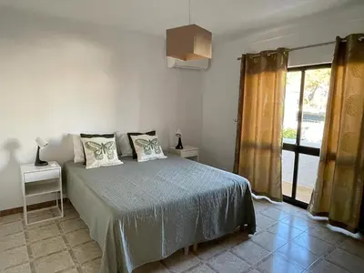 a bedroom with a bed with two pillows on it at Vivenda Duas Sentinelas 42 in Quarteira