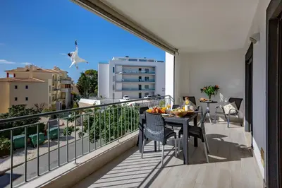 a balcony with a table and chairs and a bird at Casa do sol in Olhos de Água