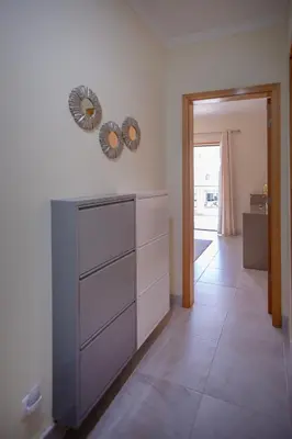 a room with a dresser with two mirrors on the wall at Casa do sol in Olhos de Água