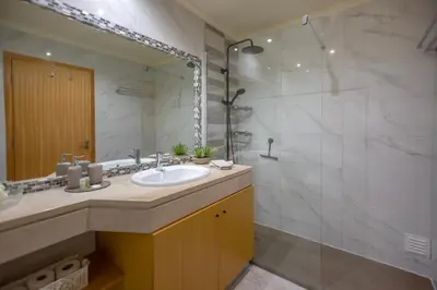 a bathroom with a sink and a shower at Casa do sol in Olhos de Água