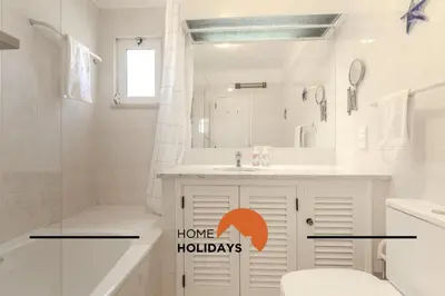a bathroom with a toilet and a sink with the words home holidays at #315 Apartamento Turistico by Home Holidays in Atalaia