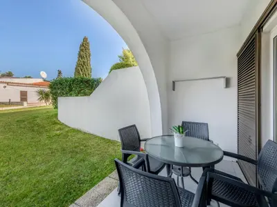 a patio with a table and chairs and a yard at Apartment Sol Salgado by Interhome in Albufeira