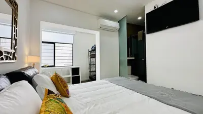 a bedroom with a bed and a tv on the wall at Pescadores by Check-in Portugal in Albufeira