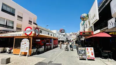 a group of people walking down a street at Pescadores by Check-in Portugal in Albufeira