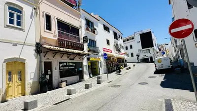 an empty street with buildings and a street sign at Pescadores by Check-in Portugal in Albufeira