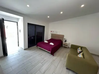 a living room with a couch and a bed at Casa Madalena in Faro