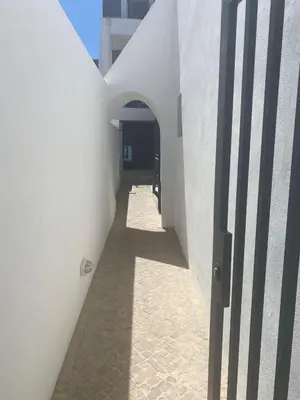 a hallway of a white building with an open door at Casa Madalena in Faro