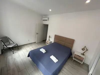 a bedroom with a blue bed with two towels on it at Casa Jonhy in Faro