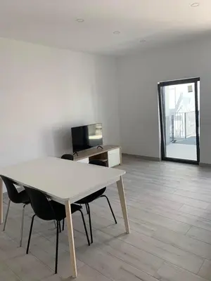 a white table and chairs in an empty room at Casa Foka in Faro