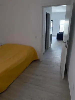 a bedroom with a yellow bed and a hallway at Casa Foka in Faro