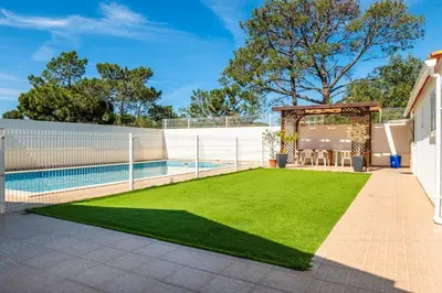 a swimming pool in front of a house at Solar do Castelo Villa with Pool in Albufeira