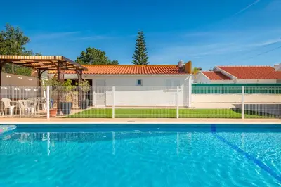 a swimming pool next to a white fence at Solar do Castelo Villa with Pool in Albufeira