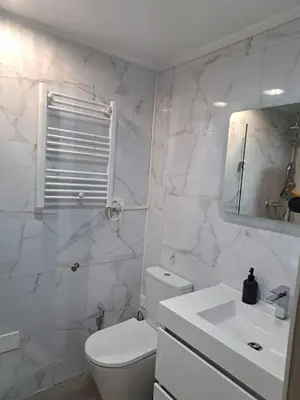 a white bathroom with a toilet and a sink at SMILE Apartment Albufeira in Albufeira