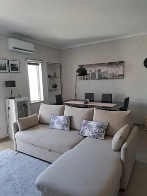 a living room with a white couch and a table at SMILE Apartment Albufeira in Albufeira
