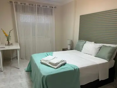 a bedroom with a bed with towels on it at Penha House II in Faro
