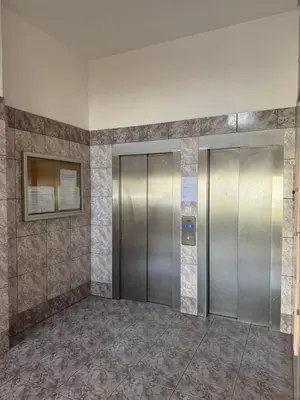 an elevator lobby with two elevators in a building at Penha House II in Faro