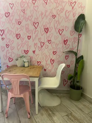 a dining room with a pink hearts wallpaper at Penha House II in Faro