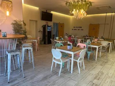 a restaurant with tables and chairs and a chandelier at Penha House II in Faro