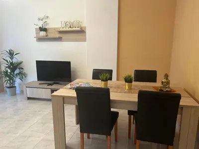 a dining room with a wooden table and chairs at Penha House II in Faro