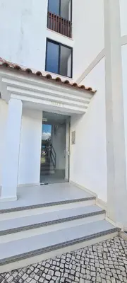 a white building with stairs leading to a door at Porto Marina Vilamoura LG Studio in Quarteira
