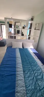 a bedroom with a large bed with a blue comforter at Porto Marina Vilamoura LG Studio in Quarteira