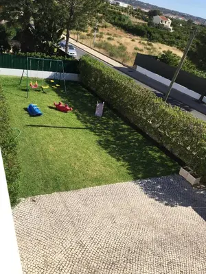 a yard with a swing set on the grass at Villa Roja Pé by Dream Villas Algarve in Albufeira